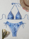Denim blue printed women's two-piece bikini with thin straps, laid flat.