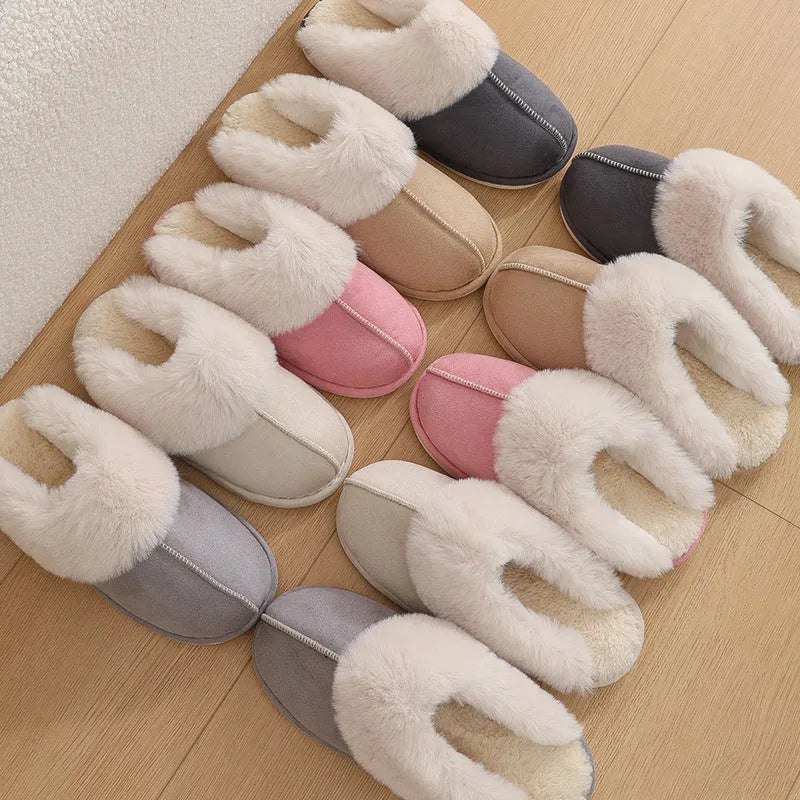 Women's brown plush indoor slippers with a round toe, flat heel, and stitching detail.