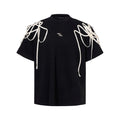 Black loose fit women's T-shirt with padded shoulders and decorative rivet ribbon detail.
