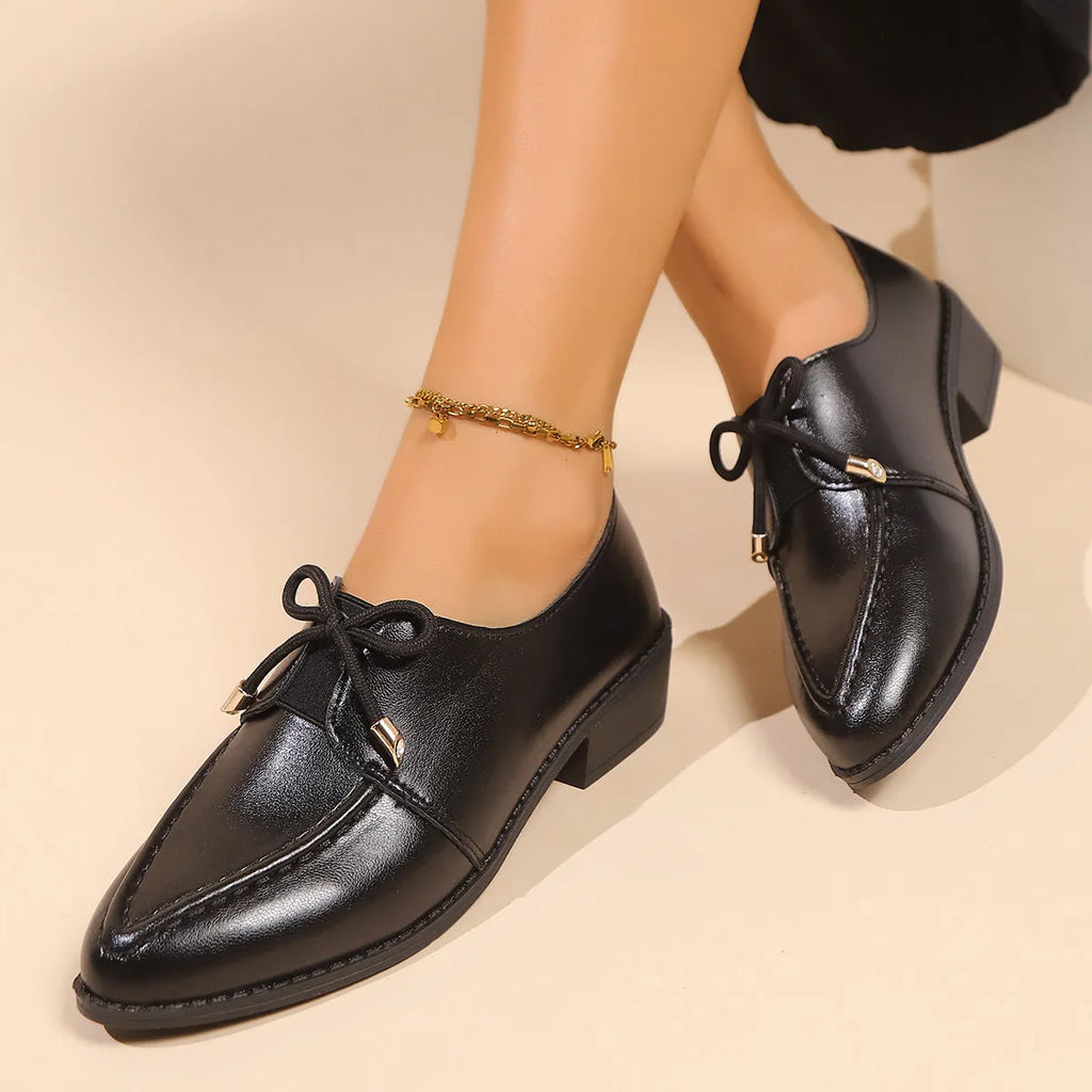 Women's pointed toe shoes with a choice of large buckle bow or small bowknot detail on a PU leather upper.