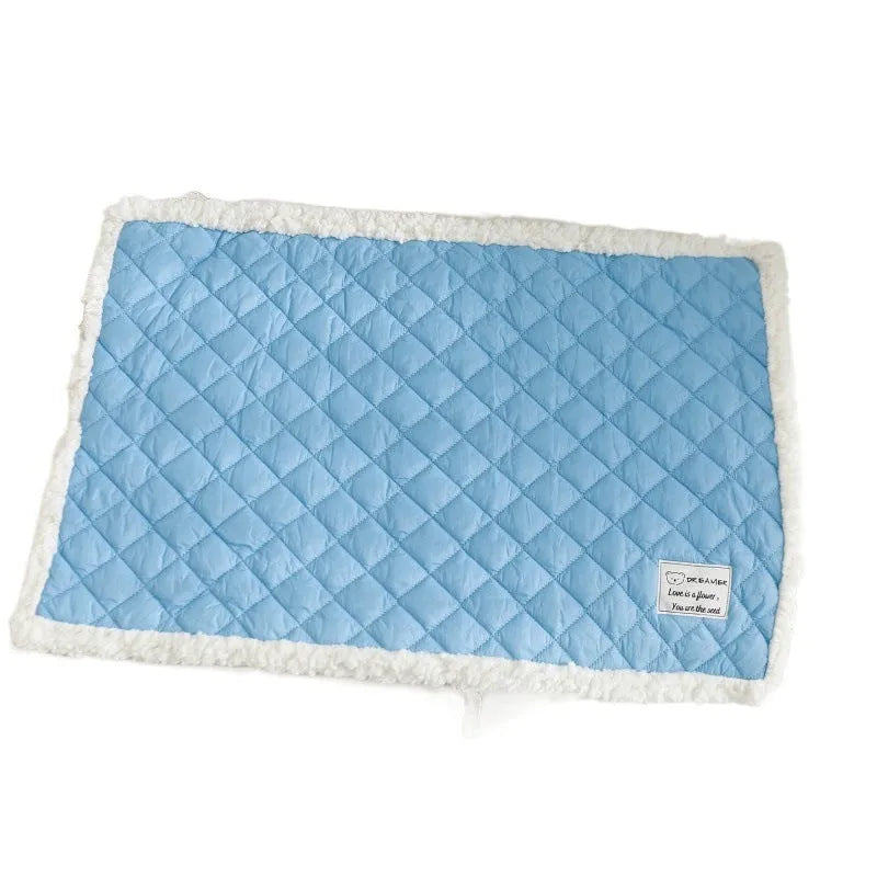 Blue quilted terry cloth cat blanket shown in a pet bed.