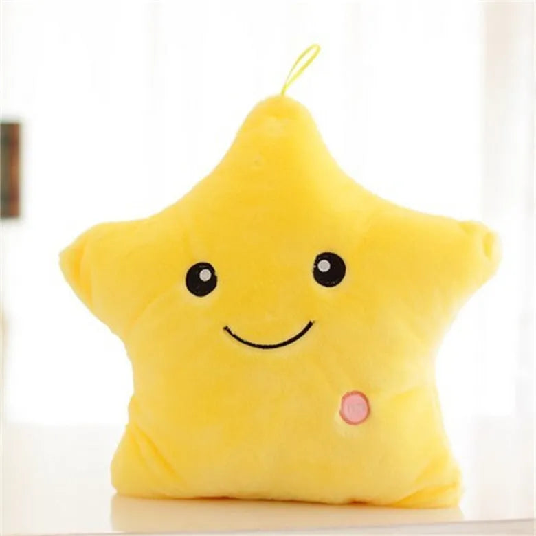 Colourful glowing five-pointed star plush pillow on a dark background, showing soft texture and LED illumination