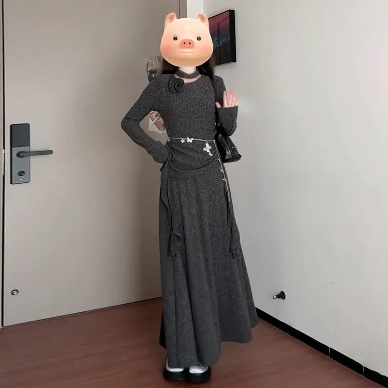 Women's gray knit dress set with neck-hanging top and long patchwork skirt on a model