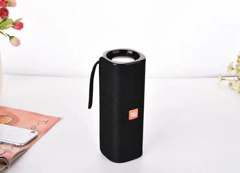 Cloth wireless Bluetooth speaker in multiple colours showing front grill and control buttons.