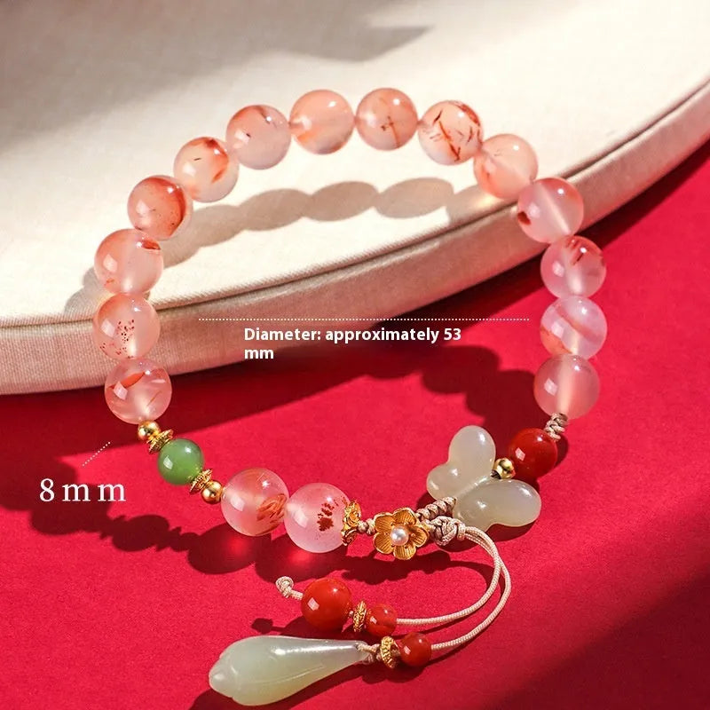 Women's ice floating south red white agate fishtail bracelet showing natural stone colour variation and textured design