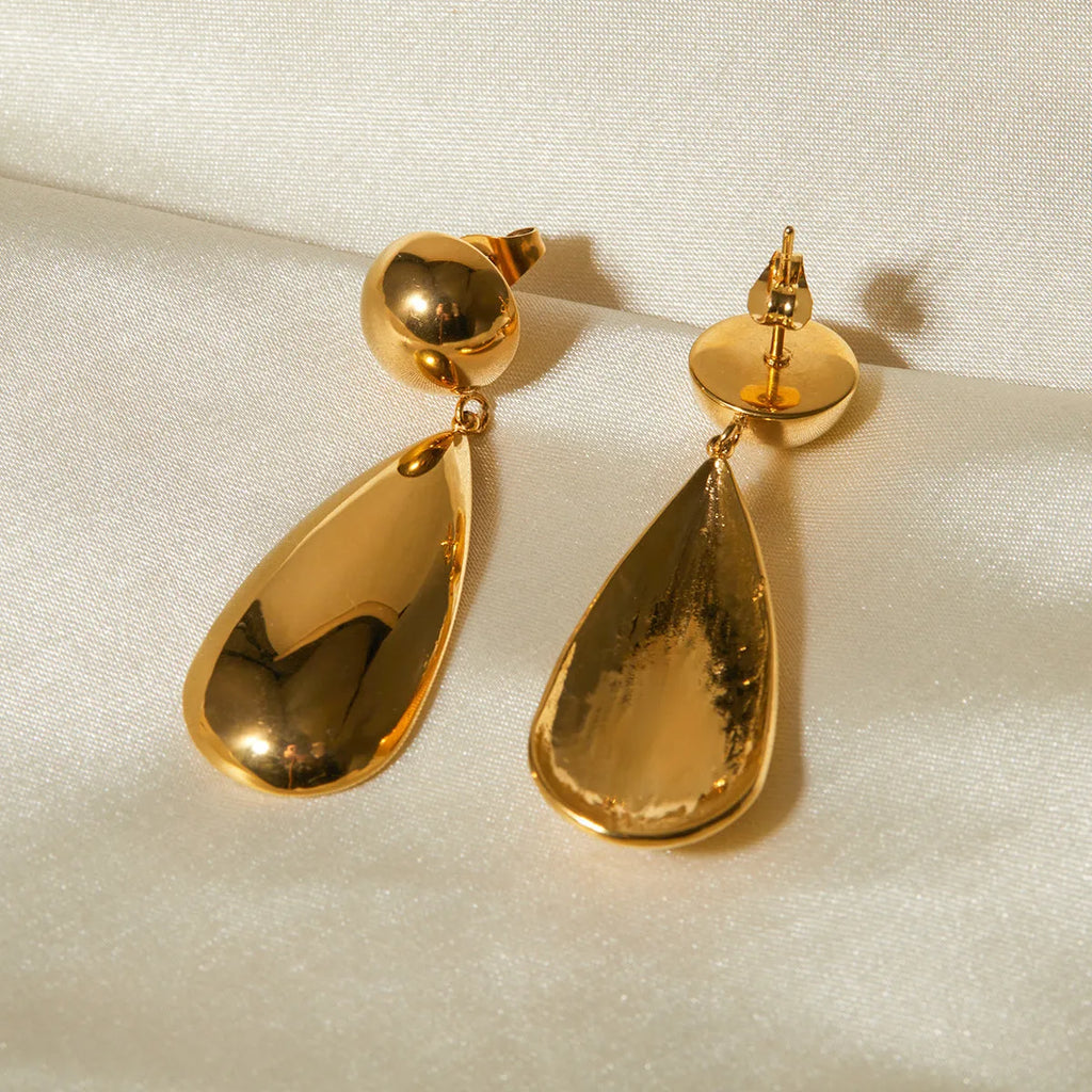 Gold stainless steel earrings with a geometric hemisphere and dangling water droplet pendant.