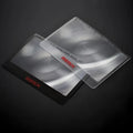 Portable plastic card magnifier for reading small text, shown in black and white colour options