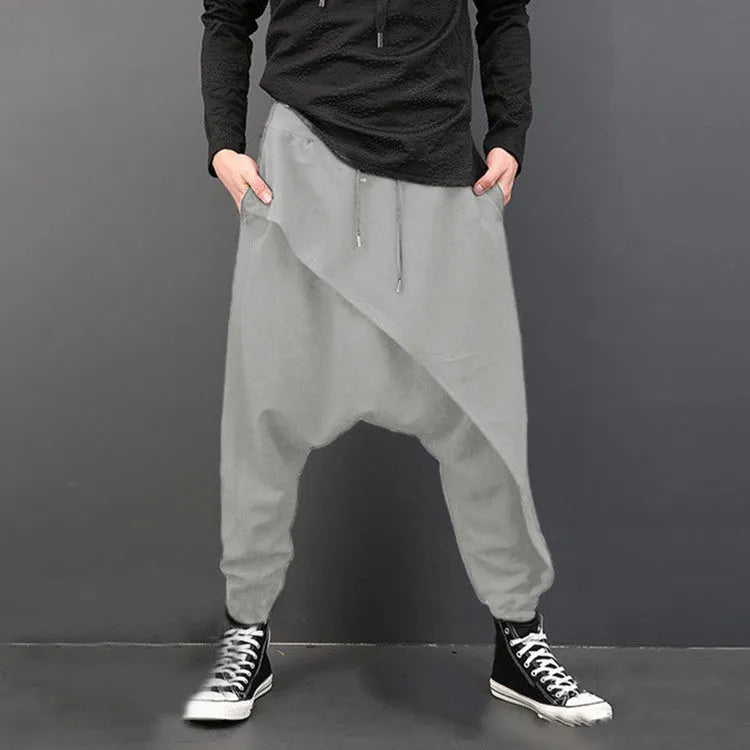 Cotton loose harem pants in black with elastic waist, side view on model