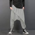 Cotton loose harem pants in black with elastic waist, side view on model