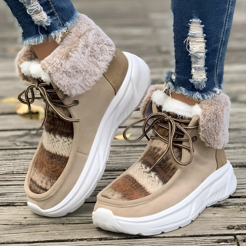 Women's beige lace-up suede snow boots with fuzzy lining and a thick non-slip rubber sole.