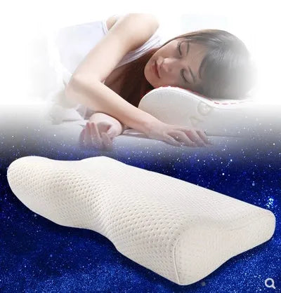 Butterfly-shaped blue memory foam cervical pillow on a bed.