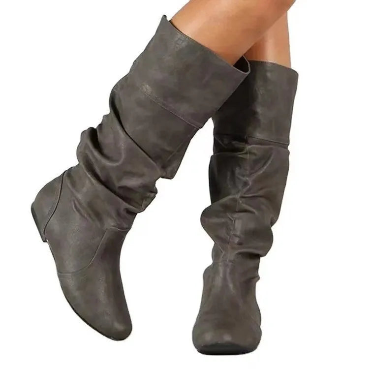 Women's flat heel knee-high slip-on boot in black with round toe and rubber sole
