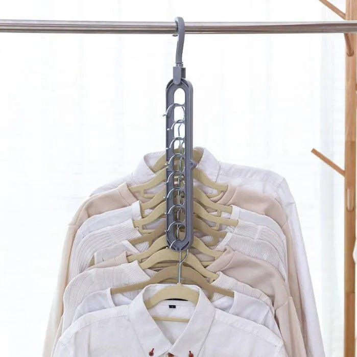 Plastic clothes hanger with rotating hook in pink colour, shown next to a green hanger.