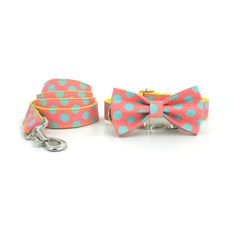 Yellow polka dot dog collar with attached lead rope and fabric bow decoration