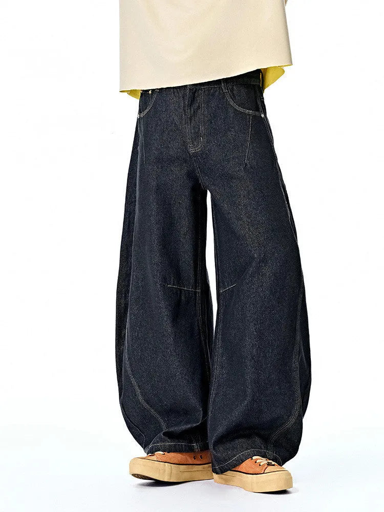 Men's wide leg denim trousers in original cow colour showing mid waist and relaxed fit.