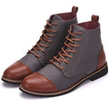 Men's black leather ankle boots with silver buckle strap on side, featuring a thick rubber sole.