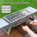 Small collapsible charcoal barbecue grill with folded legs, shown flat-packed.