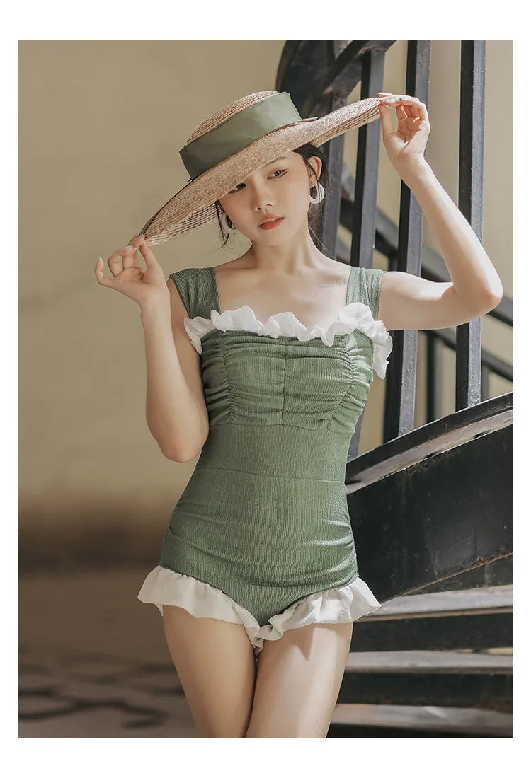 Korean-style high-waist one-piece swimsuit in black, pink, or green on a model