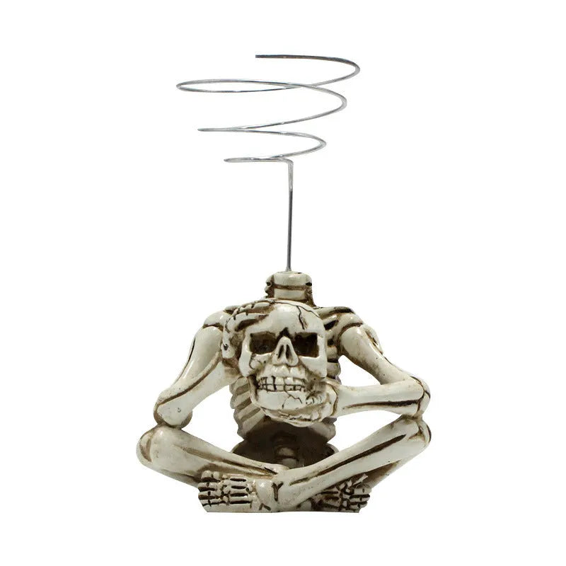 Gothic skull design resin bracket for holding soilless Tillandsia air plants.