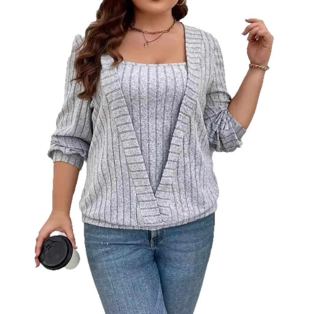 Woman wearing a solid purple V-neck long sleeve faux two-piece suit with a ribbed texture and loose fit.