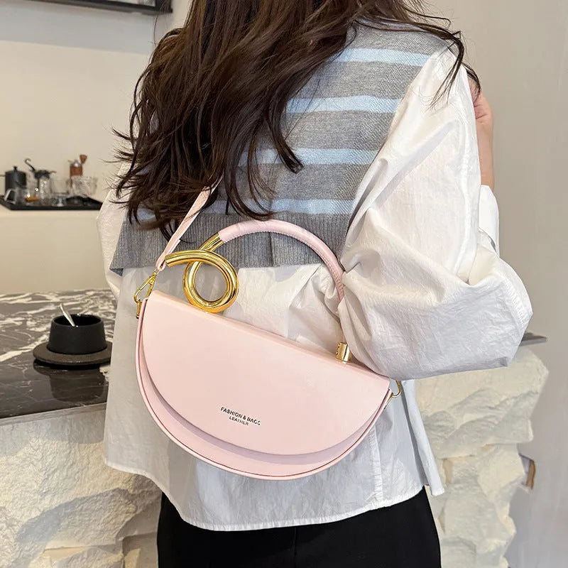 Medium hard PU box saddle bag in solid colour with internal zipper pocket and oval shape