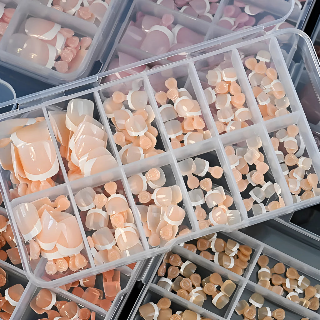 120 piece boxed set of full square short artificial toenails with French white edge design on nude base