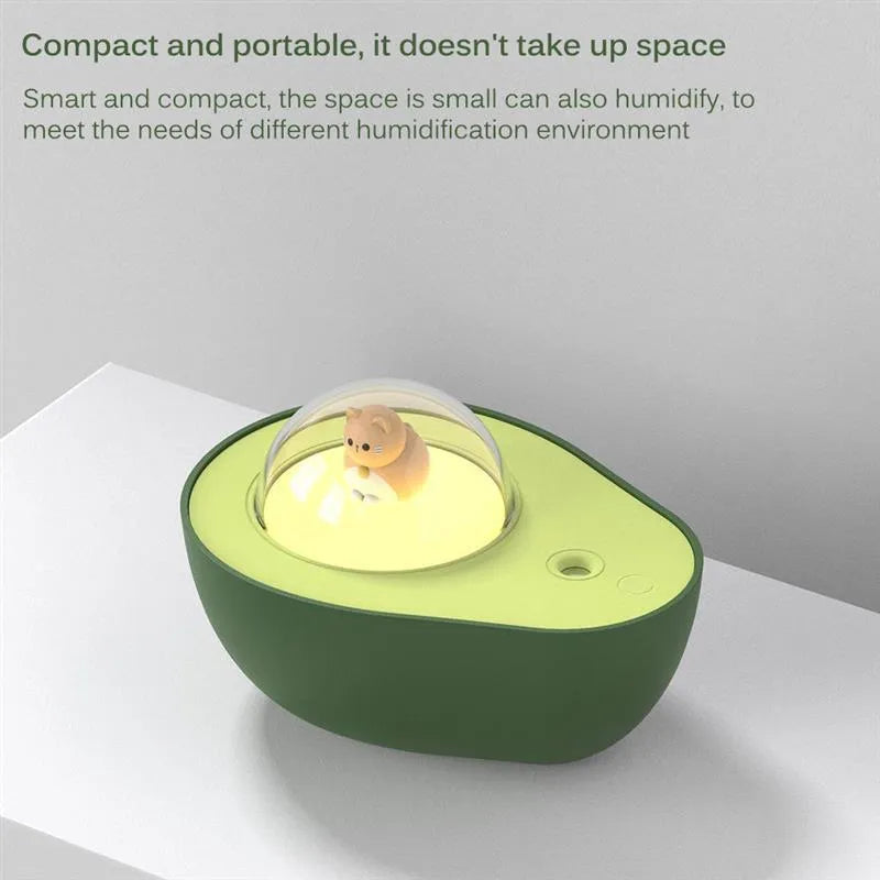 Green avocado-shaped mini humidifier with USB cable and night light on a desk