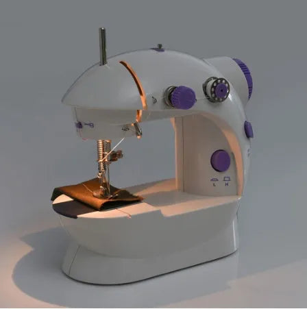 Small white plastic electric sewing machine with thread cutter and light on a table
