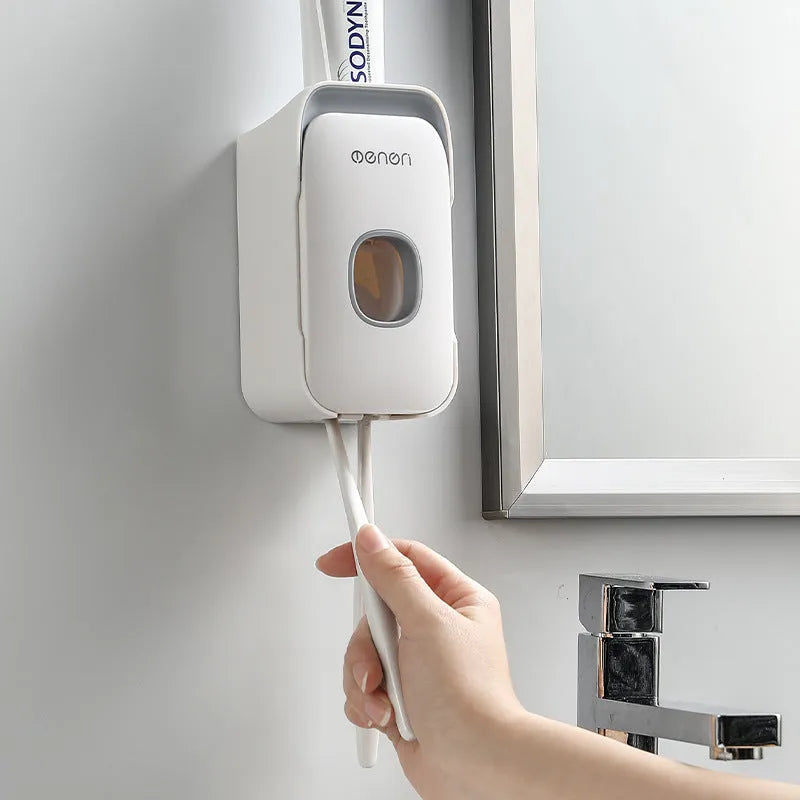 Automatic toothpaste dispenser in blue colour mounted on a bathroom wall