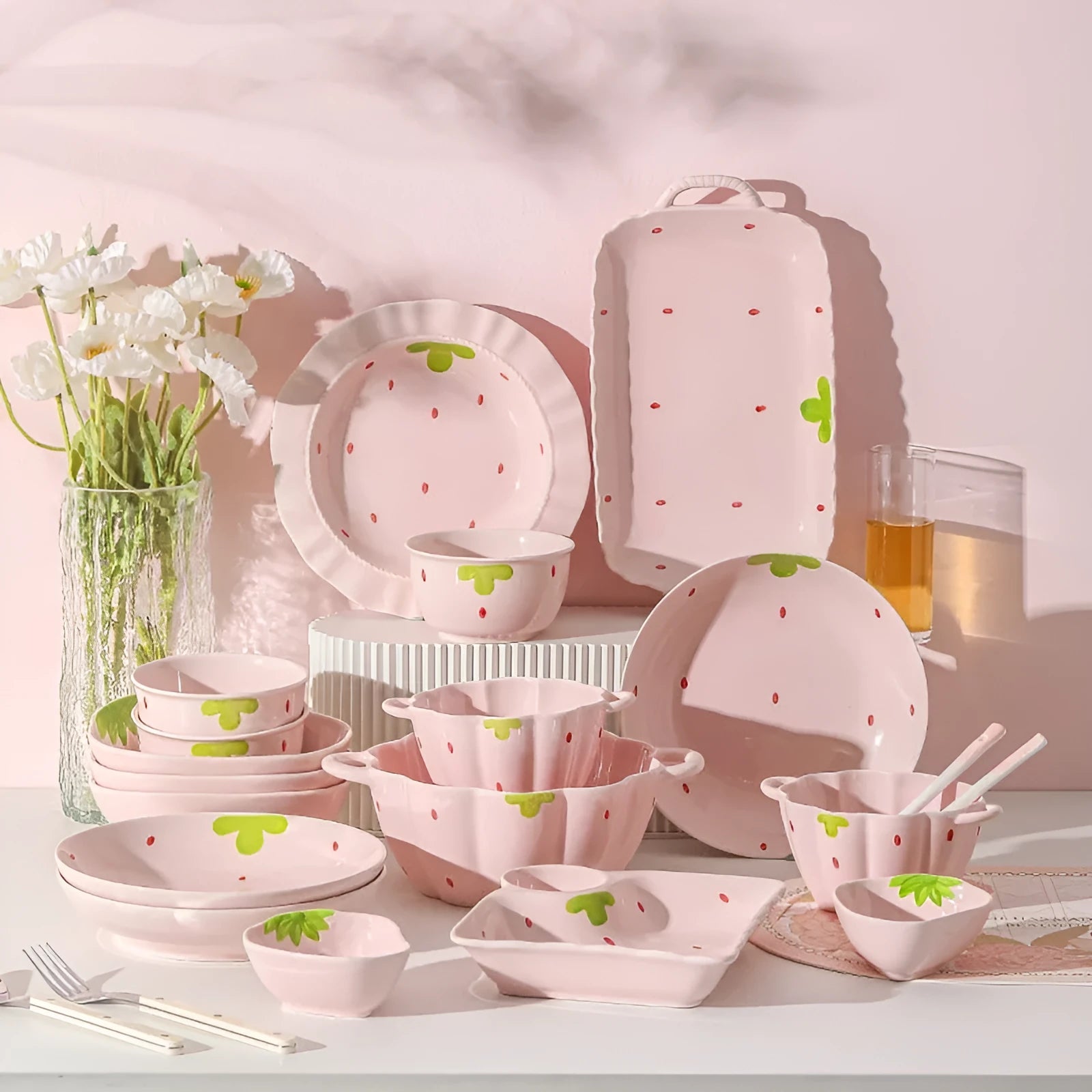 Creative strawberry-themed porcelain dinnerware set with fish plate, flower bowls, and straw hat plate.