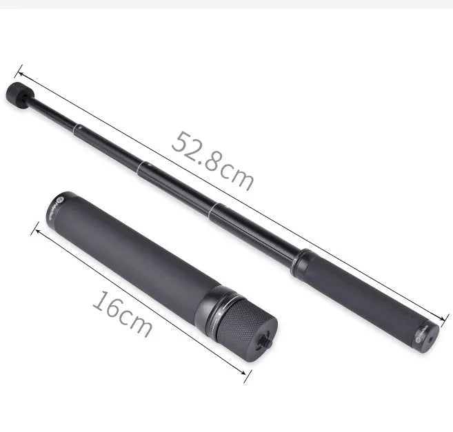 Black retractable aluminium selfie stick extended in hand next to a smartphone.