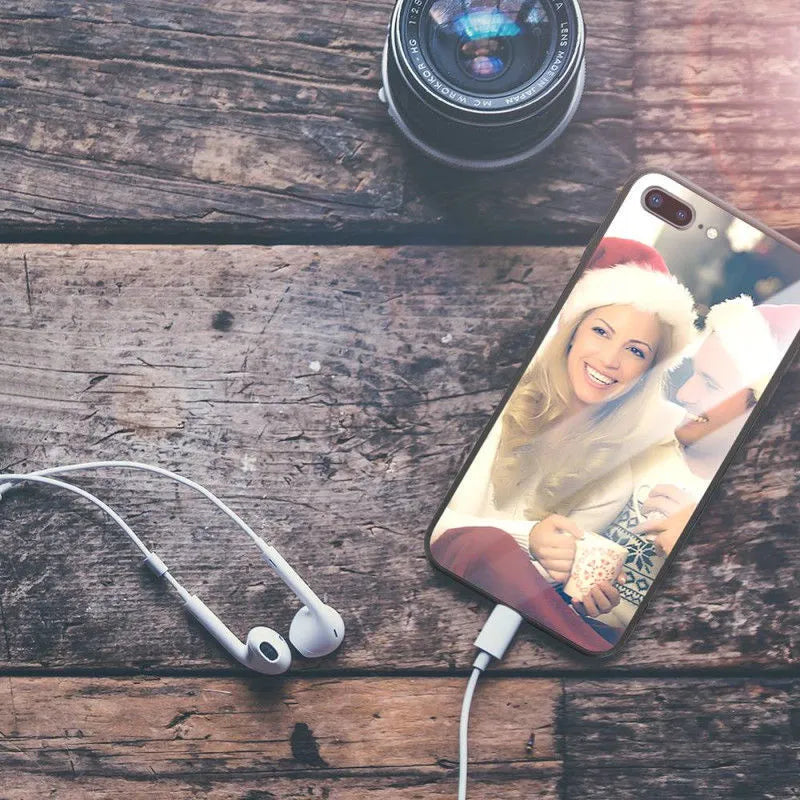 Slim patterned protective case for Apple iPhone with raised edges around screen and camera.