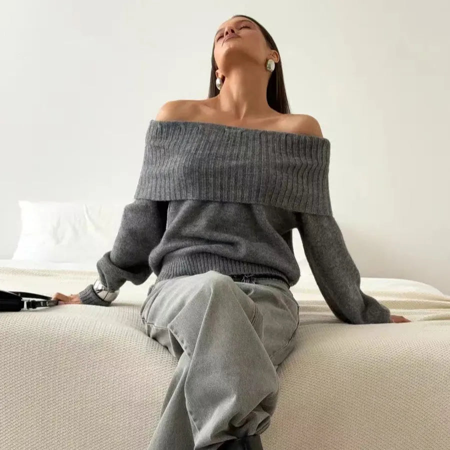 Grey off-the-shoulder sweater with a 3D pattern and strapless design on a model.