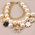 White pearl flower bracelet with simulated pearl beads, floral design, 17cm length, on a soft surface