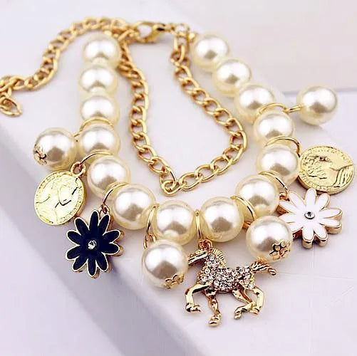 White pearl flower bracelet with simulated pearl beads, floral design, 17cm length, on a soft surface