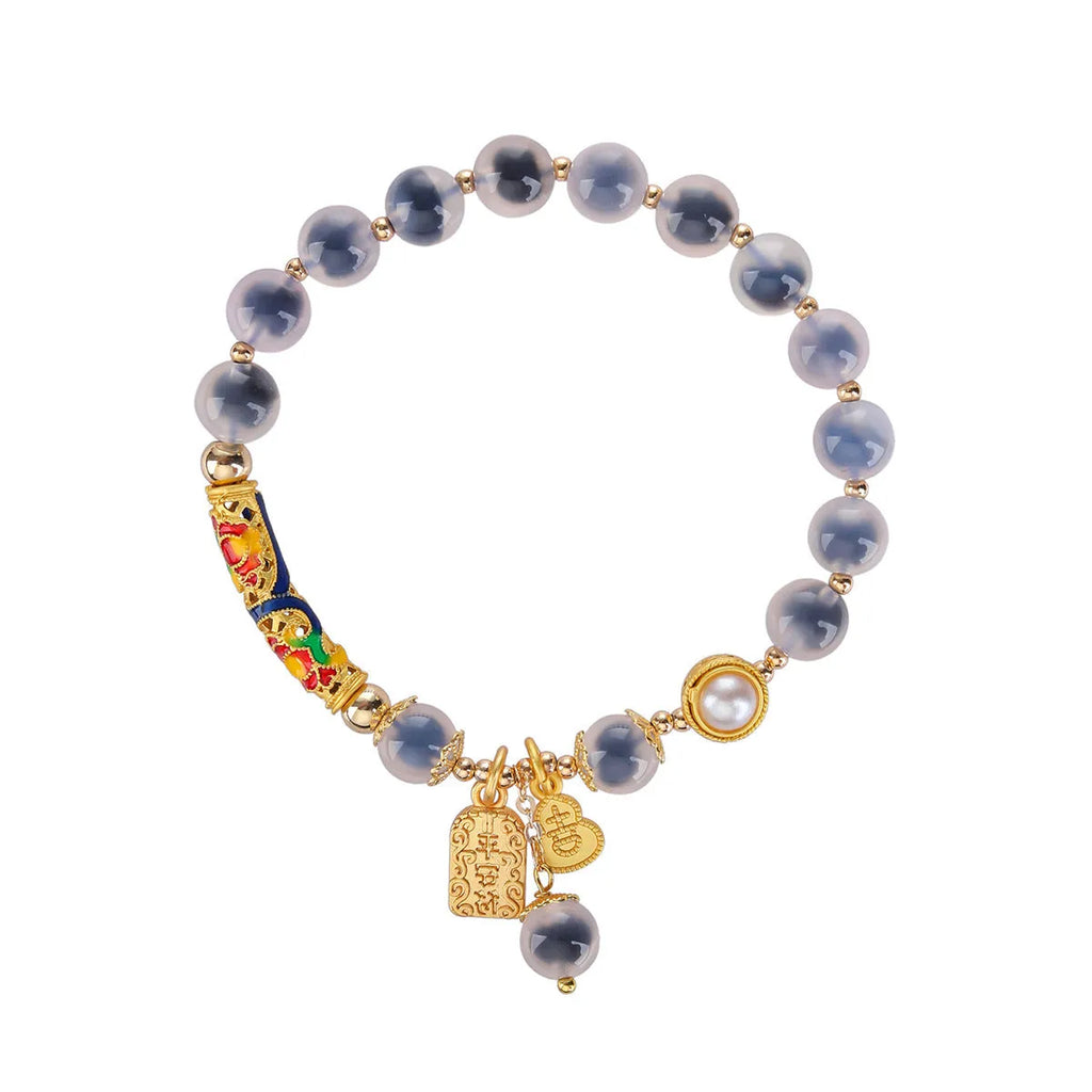 Handmade sugar heart agate bracelet with retro ethnic design on a wrist.