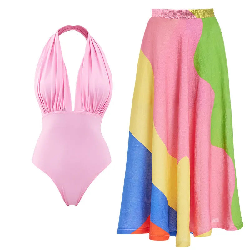 Solid colour women's one-piece swimsuit with deep V halter neck and backless design, shown with matching skirt.