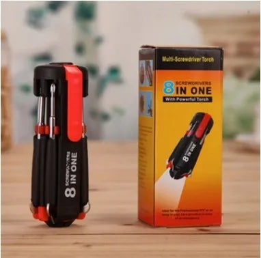 8-in-1 screwdriver with LED flashlight, magnetic bits, and stainless steel body on a workbench