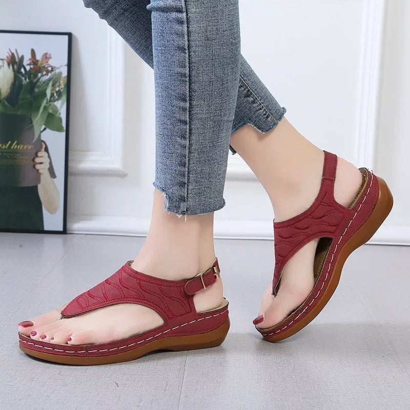 Women's black casual wedge heel sandals with an adjustable back strap buckle.