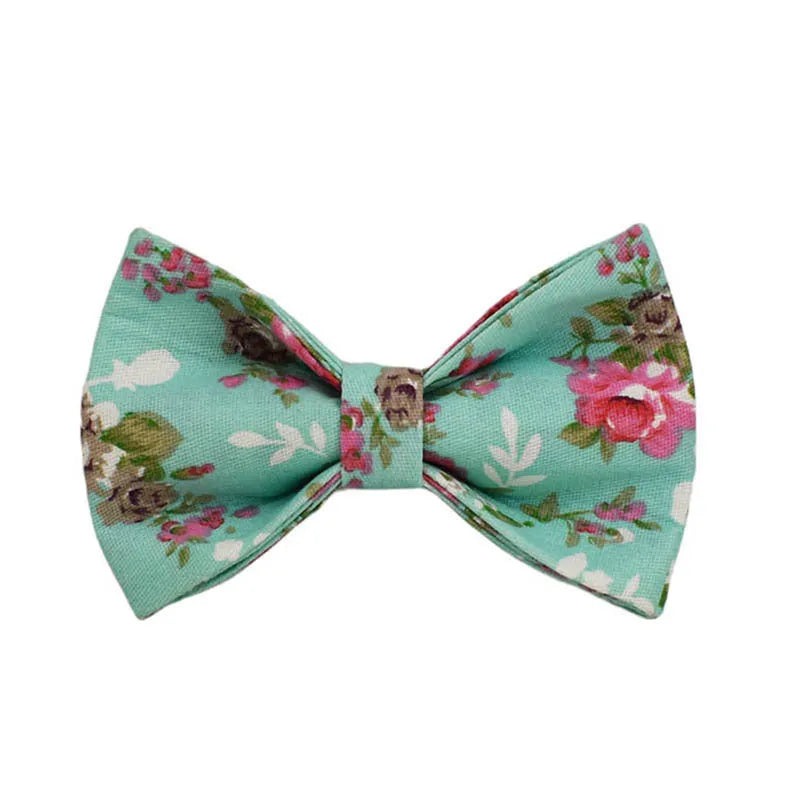 Four-piece dog accessory set with rose print bow, green fabric collar, leash and vest