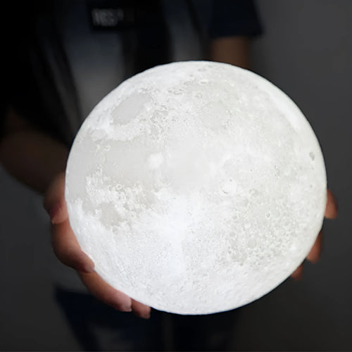 3D printed moon lamp on wooden stand showing detailed lunar surface, with touch ring at base.