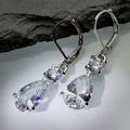 White gold drop-shaped long earrings with diamond finish on women