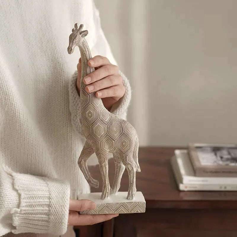 Wood colour European style giraffe resin ornament on a surface.
