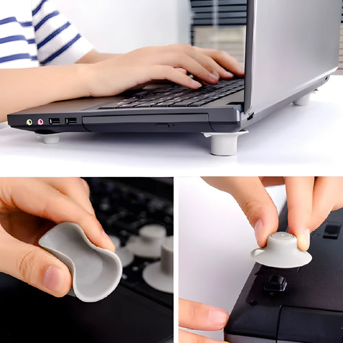 Four grey plastic laptop cooling pads, two large and two small, placed under a silver laptop on a wooden desk.