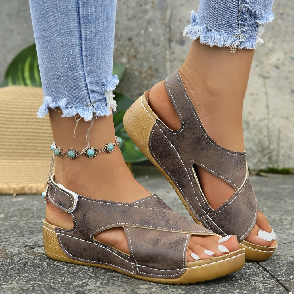 Women's brown Roman platform sandals with a skirt detail and velcro strap on a 1cm rubber sole.