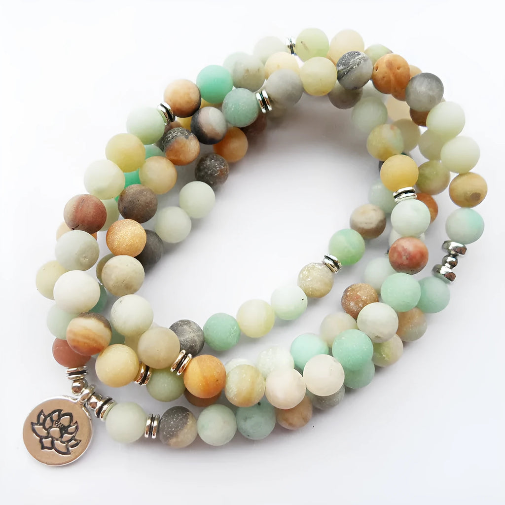 108 bead matte amazonite mala bracelet with lotus Buddha pendant on a surface