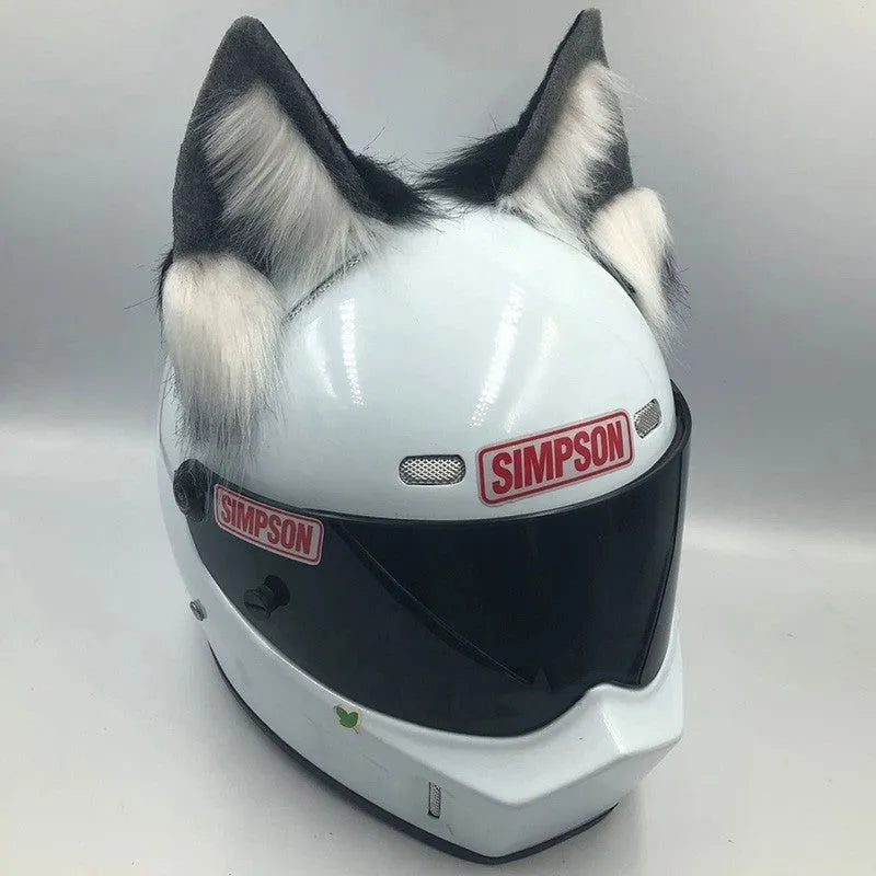 Set of black and white wolf ear and tail ornaments clipped to a motorcycle helmet