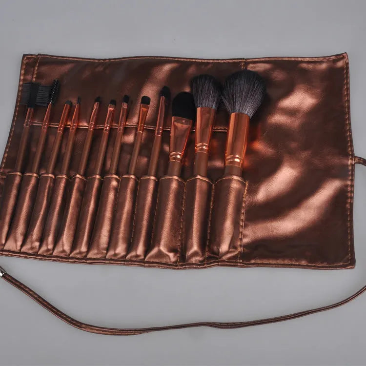Multi-function makeup brush set with synthetic fibre bristles, long plastic handles, and brown PU storage bag on a flat surface