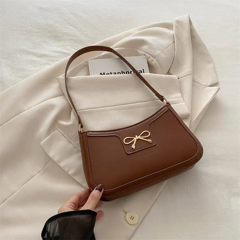 Western-style shoulder bag with bow decoration in multiple colours showing 24x14x5cm dimensions