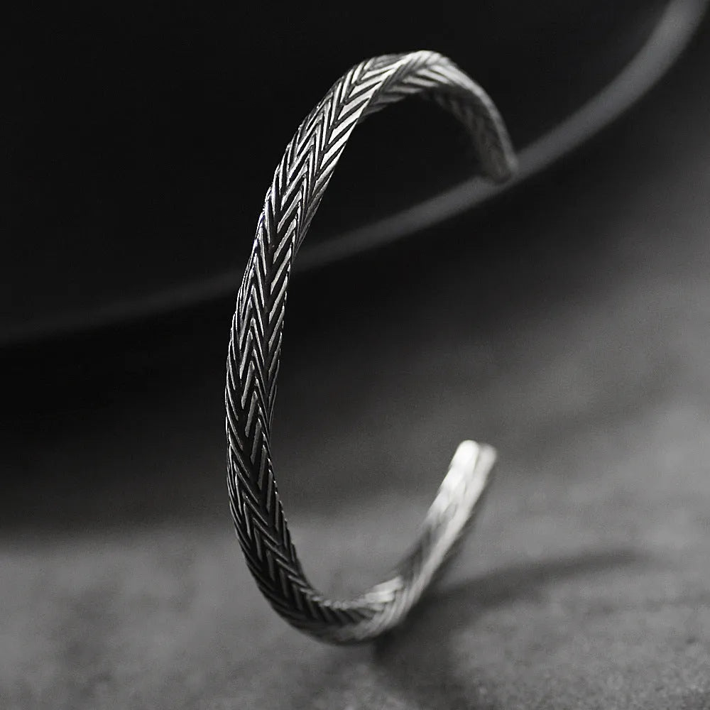 Men's white titanium steel pattern bracelet with geometric design on plain background